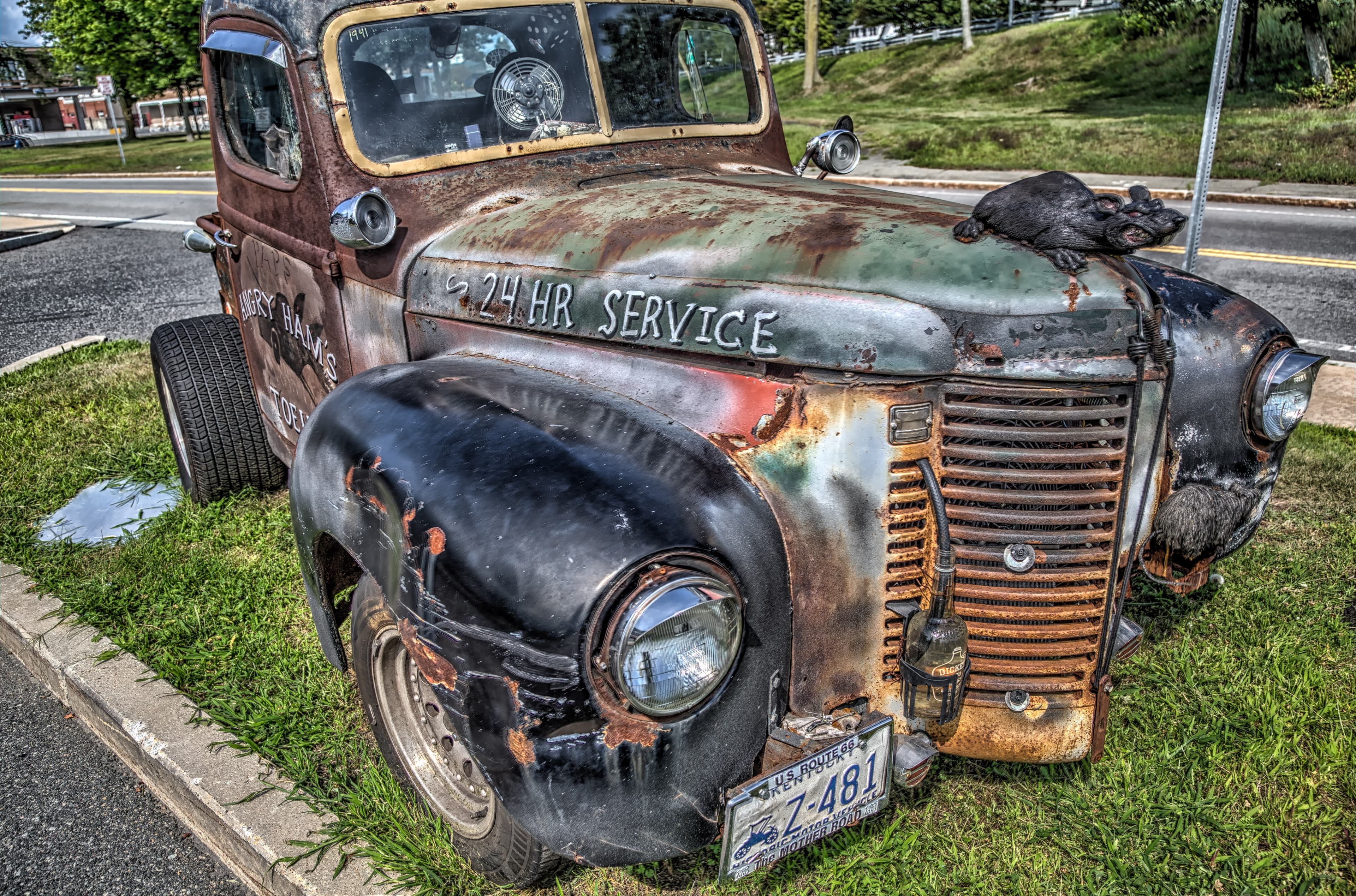 Classic car body panel with surface rust and deteriorating paint during restoration