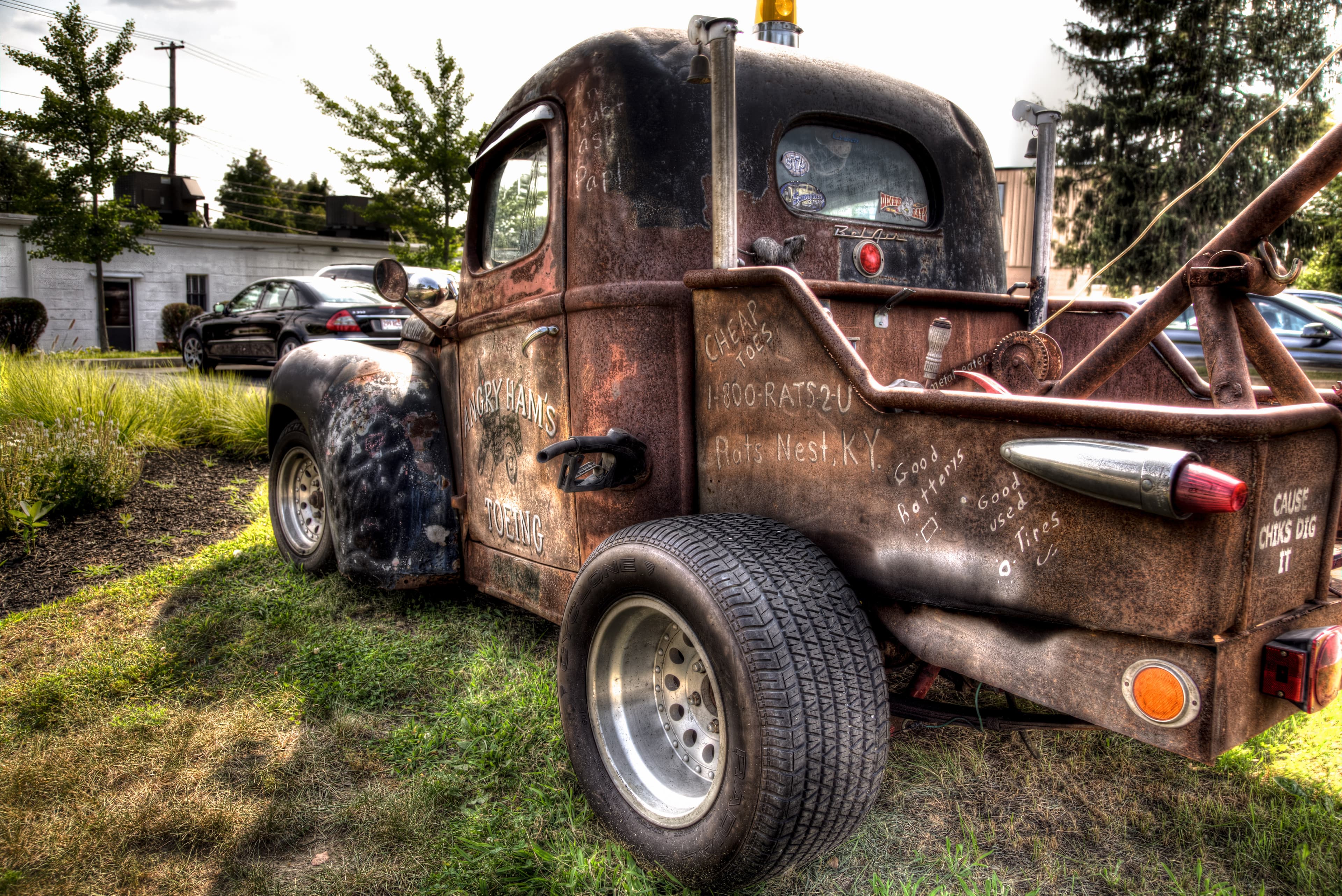 Severely deteriorated classic car body section showing scale and penetrating rust through the metal