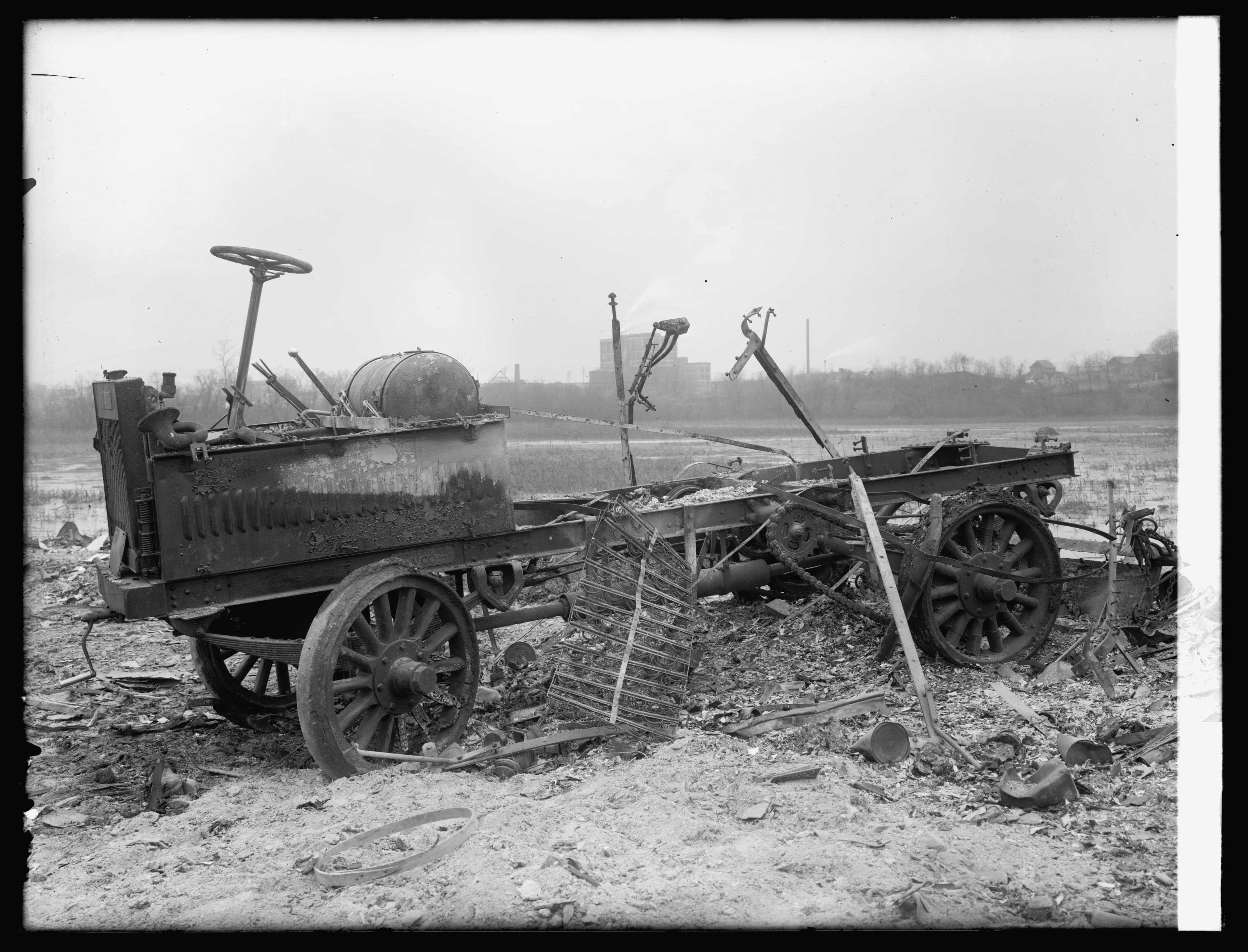 Historic photograph of an early automobile destroyed by fire, circa 1910s