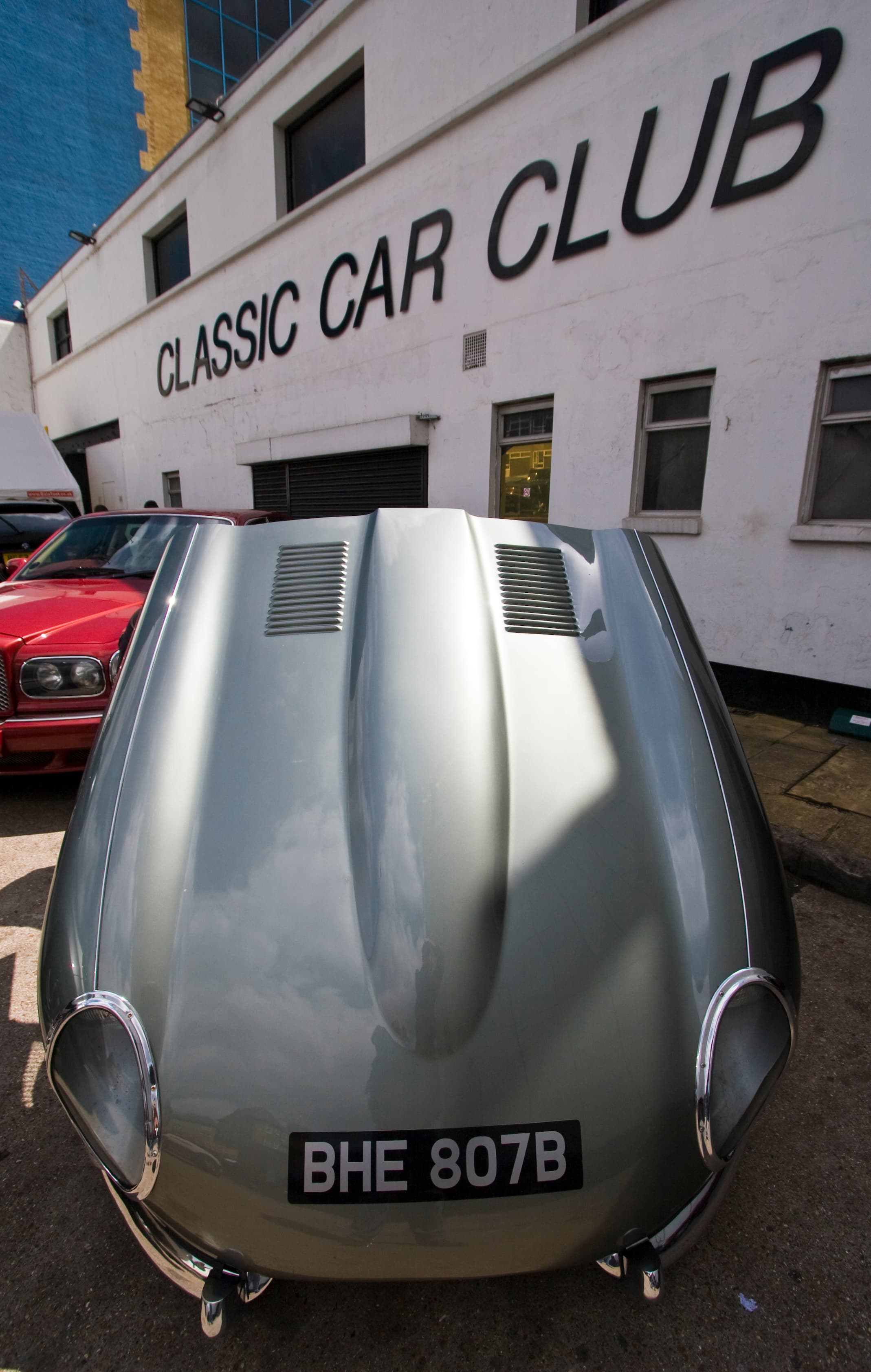 Classic car club gathering in London with vintage vehicles and enthusiasts